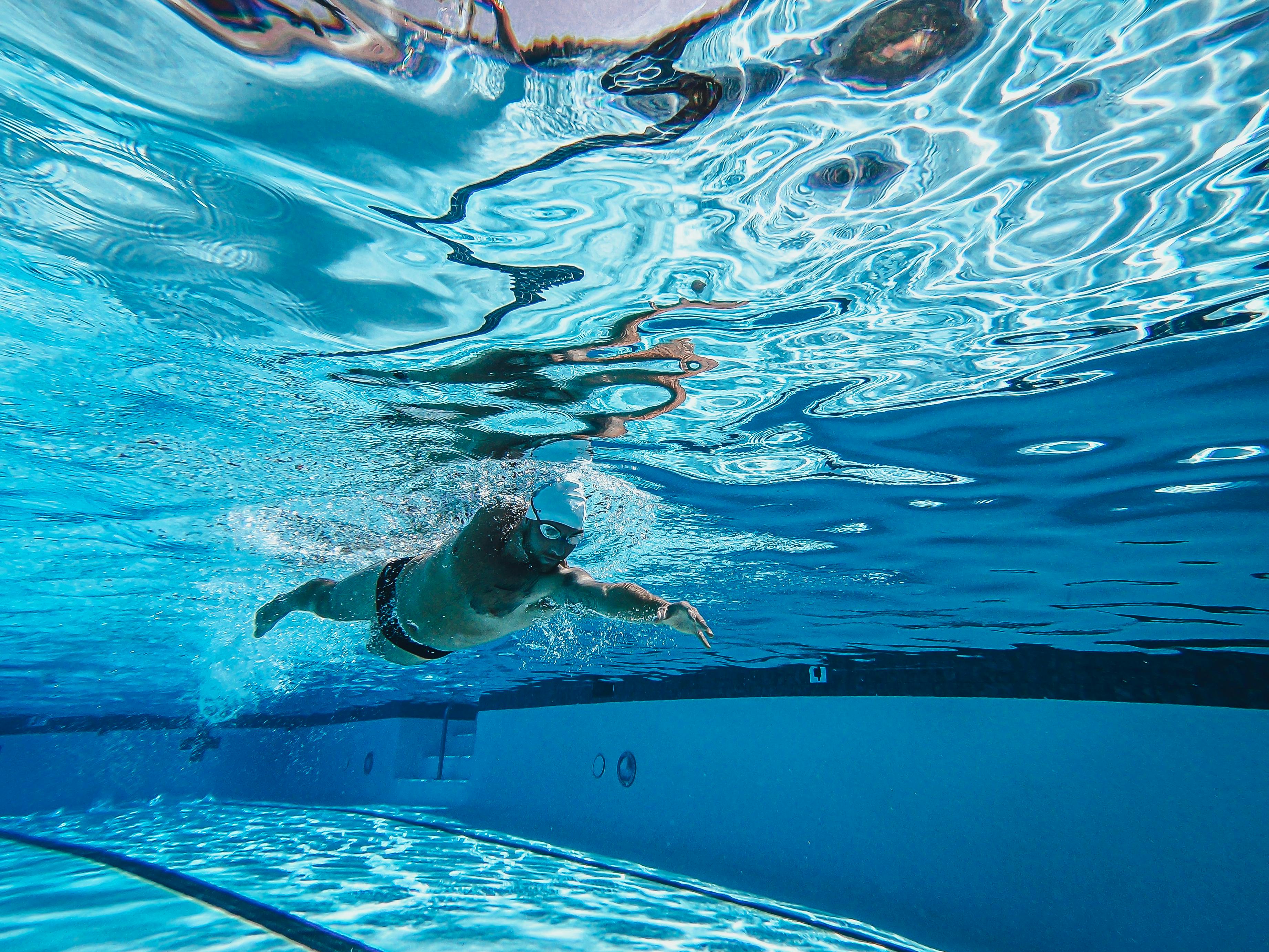 Swim coach working with young swimmers